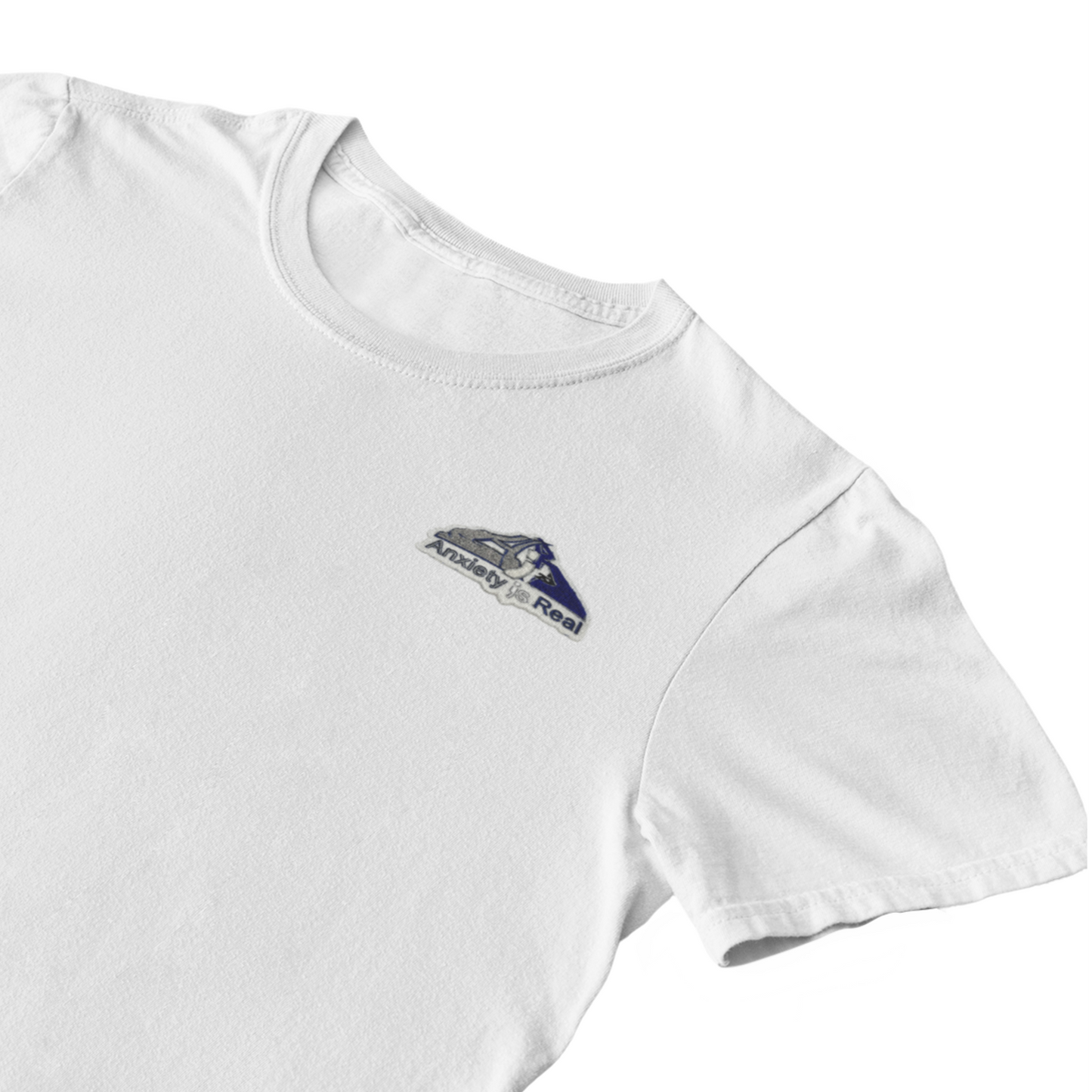 White cotton short sleeve tshirt with grey, navy and white anxiety is real chenille patch on left chest area.